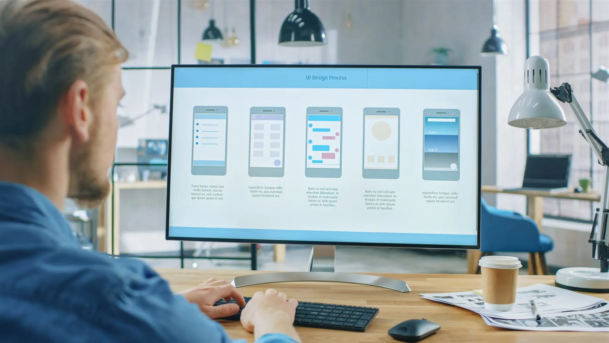 Designer working on website layouts at a desktop screen